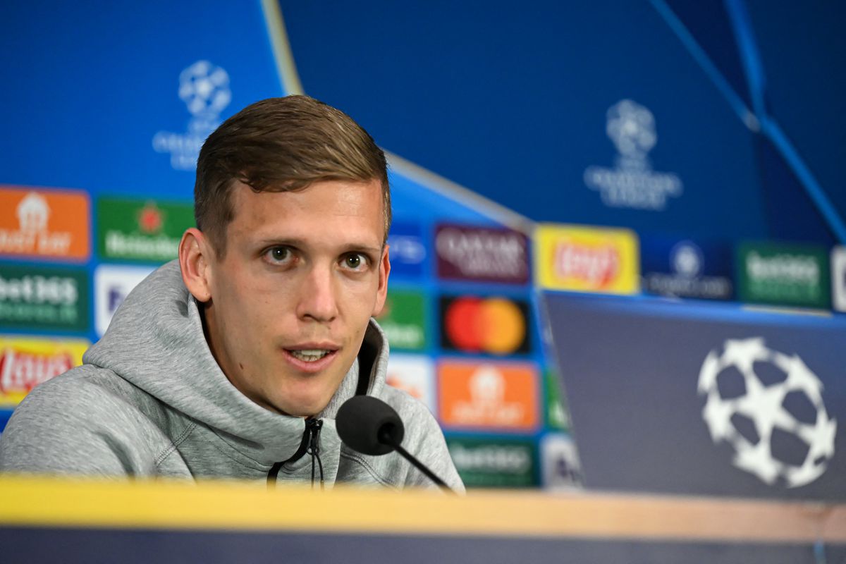 Dani Olmo celebrates with teammates in a crucial Champions League match, leading Barcelona to a pivotal victory.