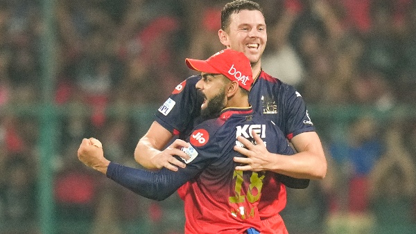 Fans cheering at Chinnaswamy Stadium for an RCB match, representing the excitement surrounding RCB tickets